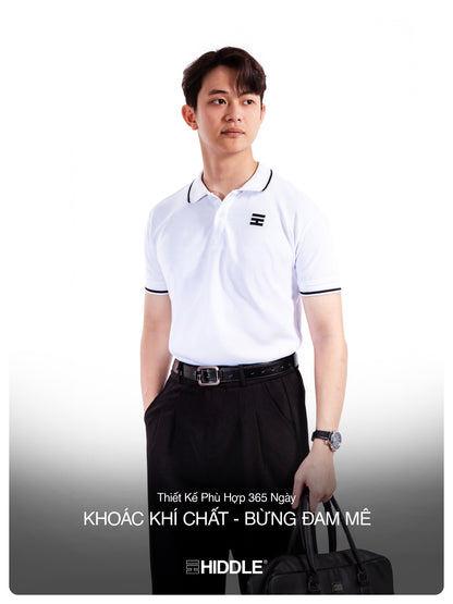 Man wearing a white polo shirt with a logo, black pants, and carrying a black bag on a white background.
