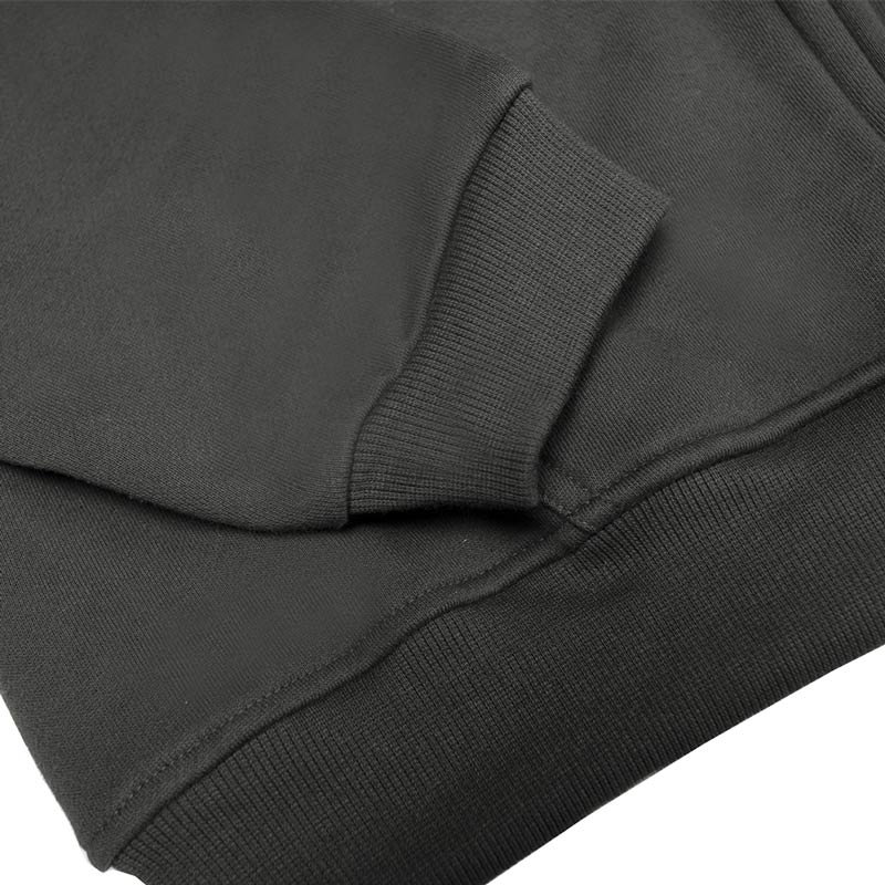 Close-up of a dark gray sweatshirt with a focus on the sleeve and hem.