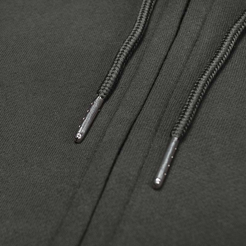 Close-up of black shoelaces on a dark fabric background