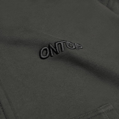 Close-up of a brand logo on a dark fabric surface