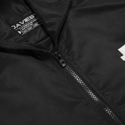 Close-up of a black jacket with a zipper and visible brand logo.