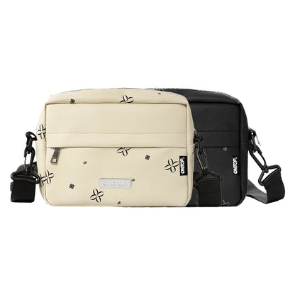 Two-tone beige and black bag with floral patterns on a white background