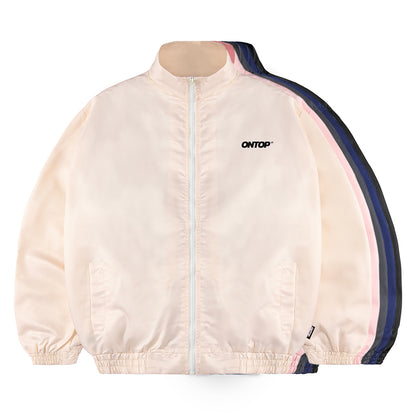 Cream-colored jacket with navy accents on a white background