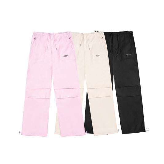 Three pairs of pants in pink, beige, and black on a white background