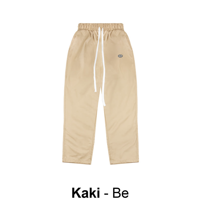 Beige pants with a brand logo on a white background
