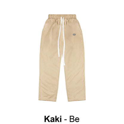Beige pants with a brand logo on a white background