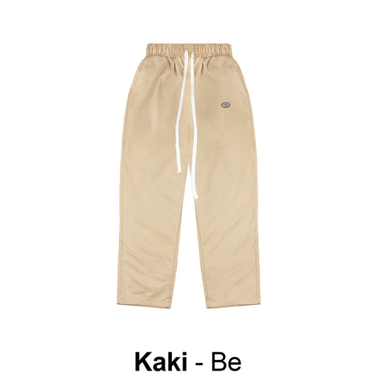 Beige pants with a brand logo on a white background