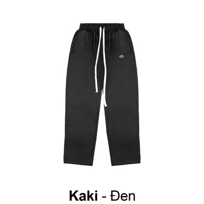 Black pants with a white drawstring on a white background