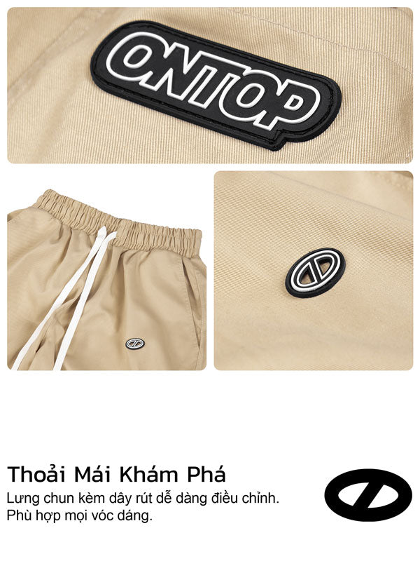 Beige pants with 'Onep' logo patch on a beige background