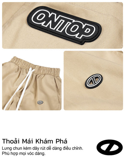 Beige pants with 'Onep' logo patch on a beige background