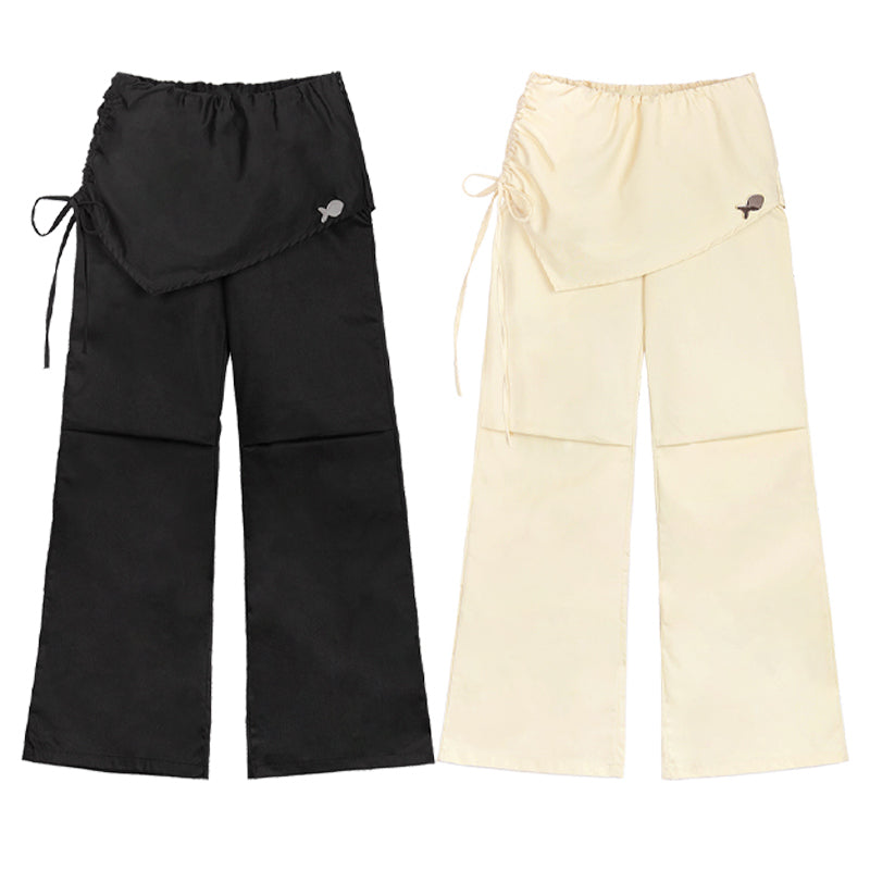 Black and beige wide-leg pants with drawstring waist on a white background