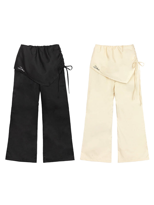 Black and beige pants with drawstring on a white background