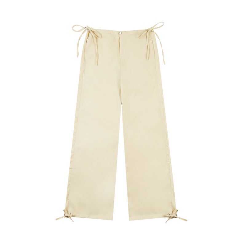 Beige wide-leg pants with tie details on a white background