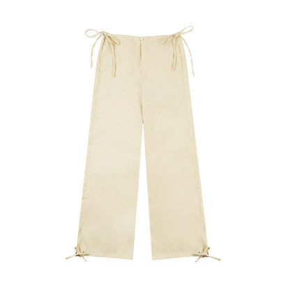 Beige wide-leg pants with tie details on a white background