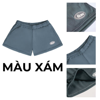 Gray shorts with a brand logo on a white background, showing close-up details.