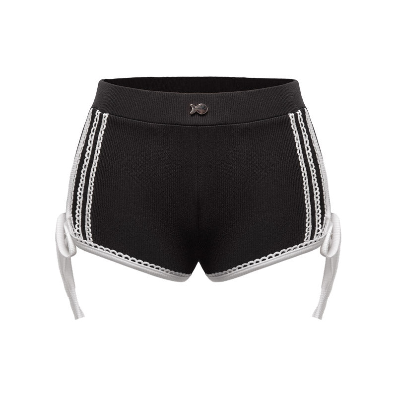 Black shorts with white lace trim on a white background