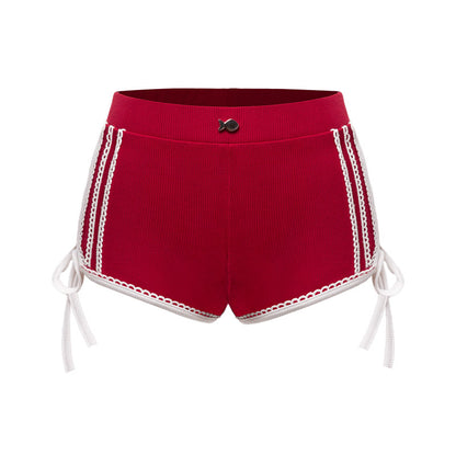 Red shorts with white lace trim on a white background