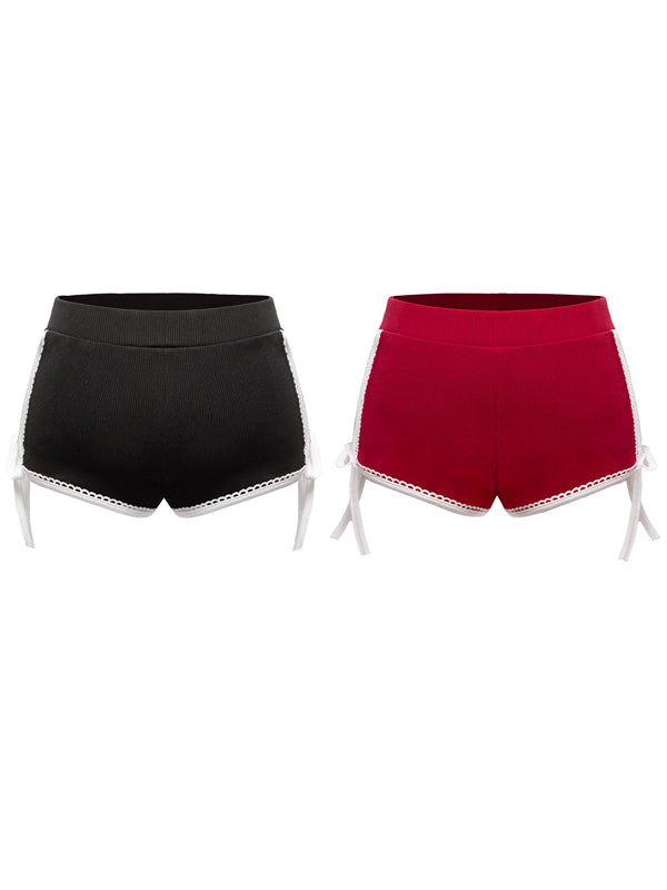 Black and red shorts with lace trim on a white background