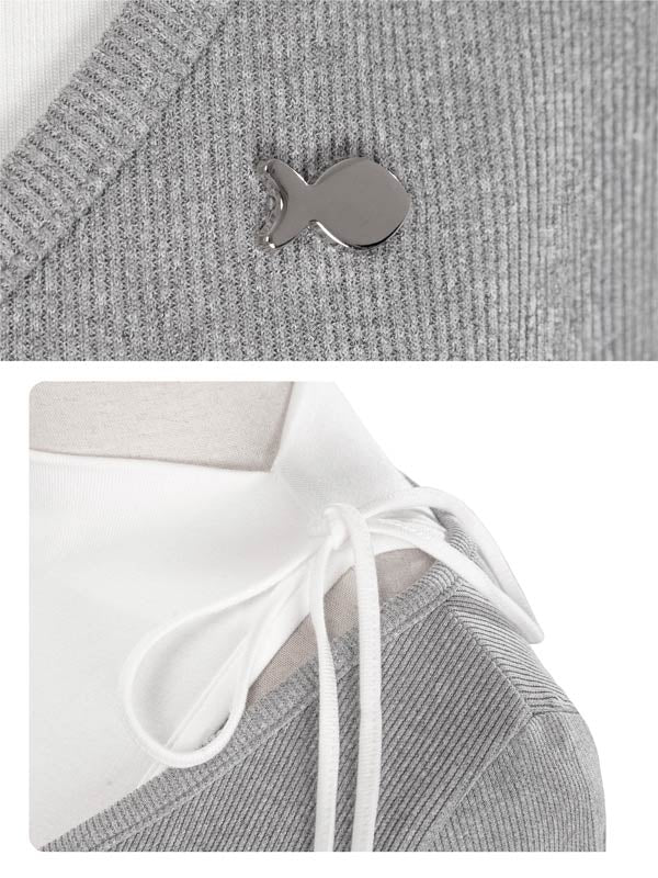Gray knit garment with a small fish-shaped button and white drawstring.