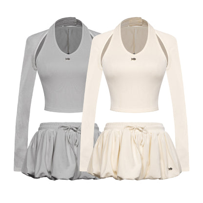Two sets of athletic wear with long-sleeve tops and skirts in gray and white on a white background.