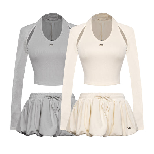 Two sets of athletic wear with long-sleeve tops and skirts in gray and white on a white background.