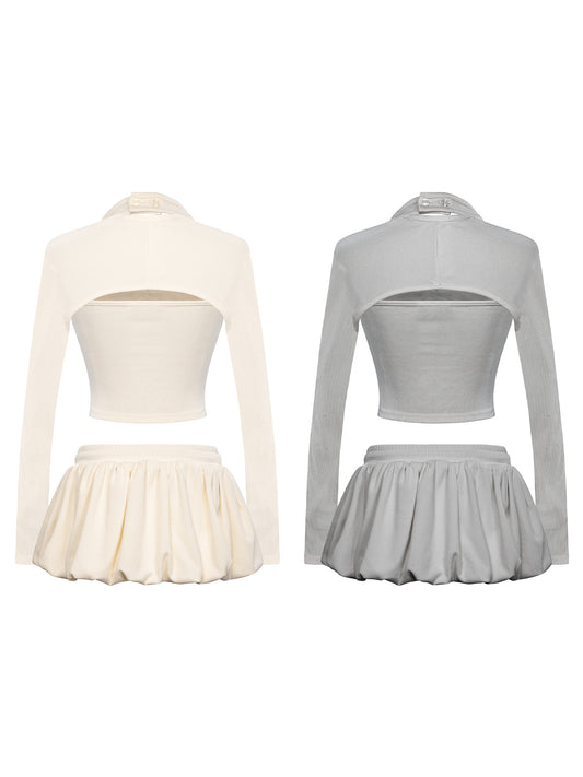 Two outfits with long-sleeve crop tops and pleated skirts, one in white and the other in gray, on a white background.