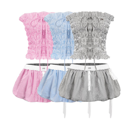 Three strapless tops with skirts in pink, blue, and gray on a white background