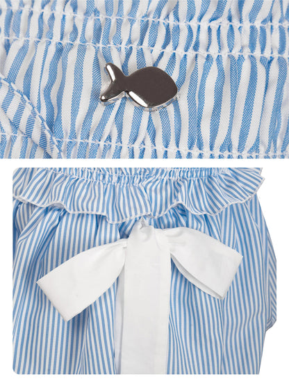 Blue and white striped outfit with a bow and fish brooch.