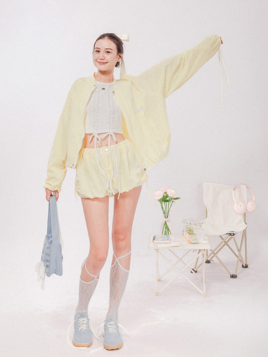 Person wearing a light yellow outfit with a white background