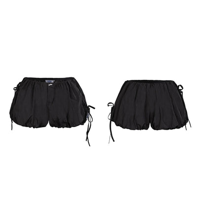 Black shorts with drawstring on a white background
