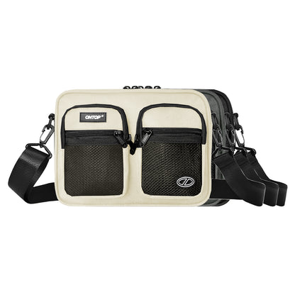 Beige crossbody bag with black accents on a white background