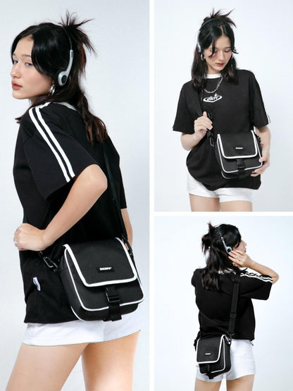 Woman wearing a black bag with white accents in various poses on a white background