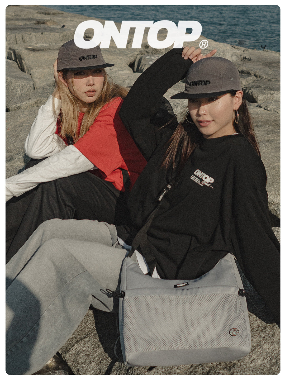 Two people sitting on a rocky beach with 'ONTOP' branding.