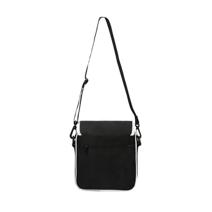 Black crossbody bag with a strap on a white background