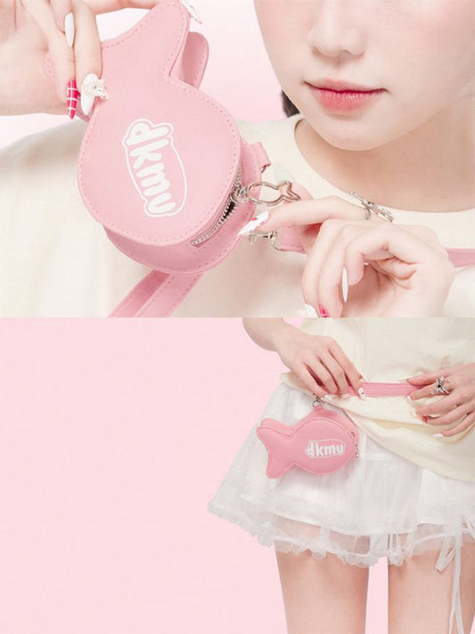 Pink heart-shaped pouch with a logo held by a person, with a close-up of the logo above.