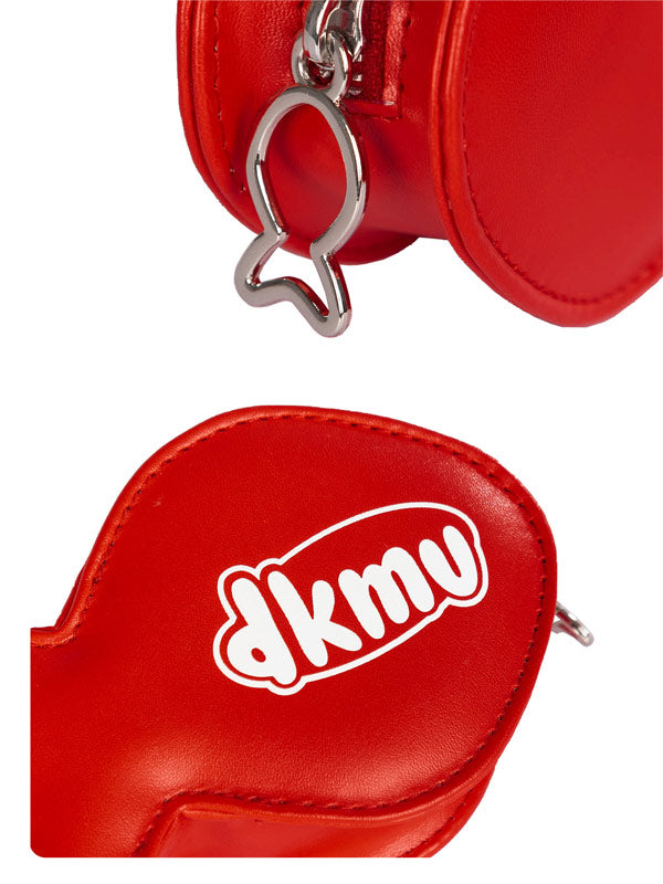 Red leather pouch with a cat-shaped keychain and 'dkmv' logo on a white background