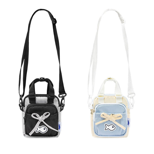 Two small bags, one black and one light blue, with decorative elements on a white background.