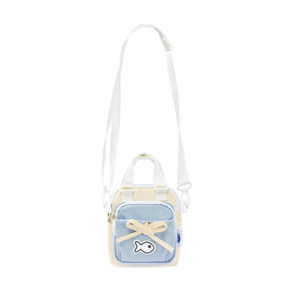 Small crossbody bag with a light blue front panel and white strap on a white background