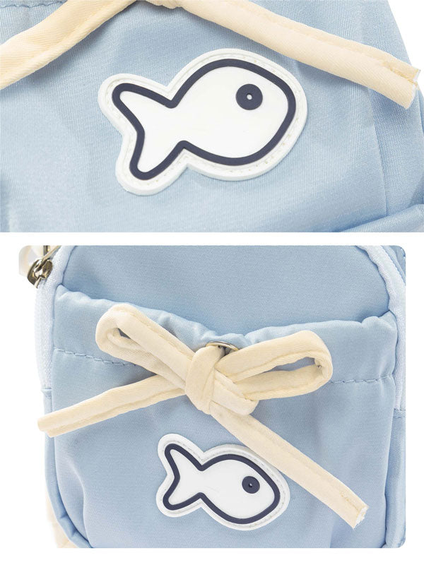 Light blue pouch with fish design and wooden stick on a white background
