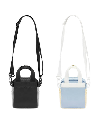 Black handbag with strap and light blue handbag with white strap on a white background