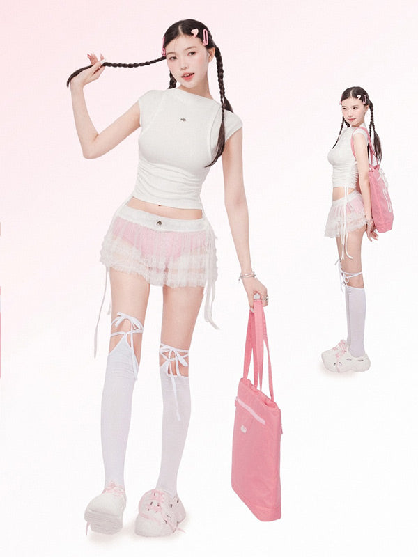 Person wearing a white top, pink skirt, and white knee-high socks with a pink bag on a white background