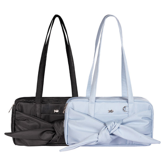 Black and light blue handbags with bow details on a white background