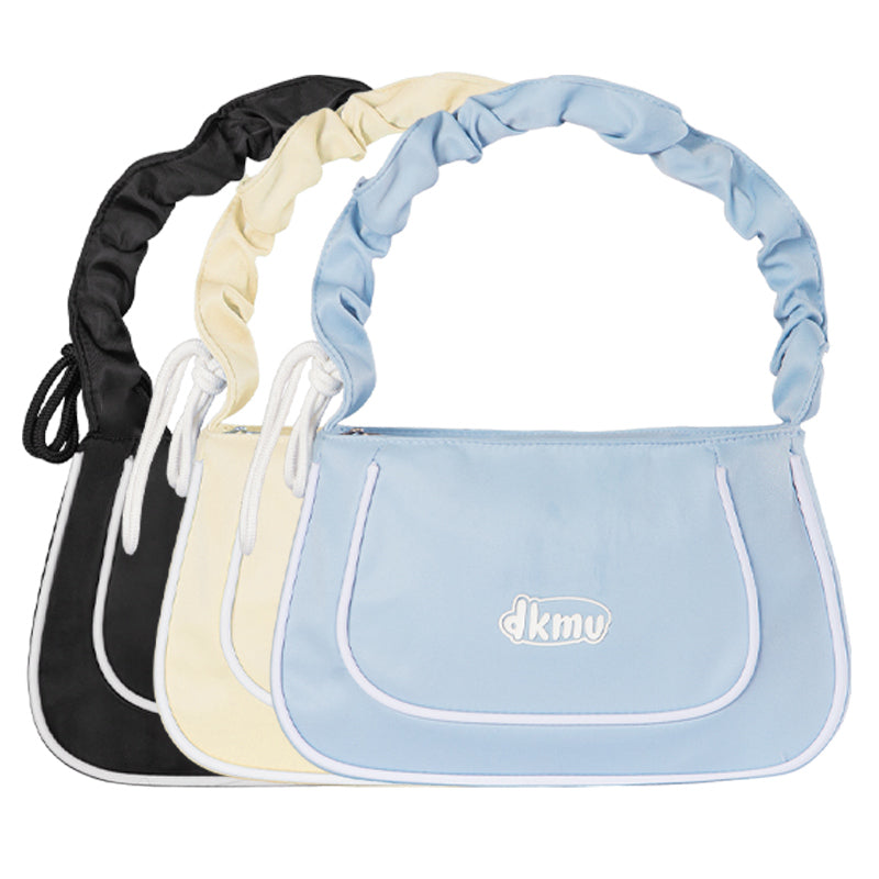 Set of three bags in black, beige, and blue with 'dkmv' branding on a white background