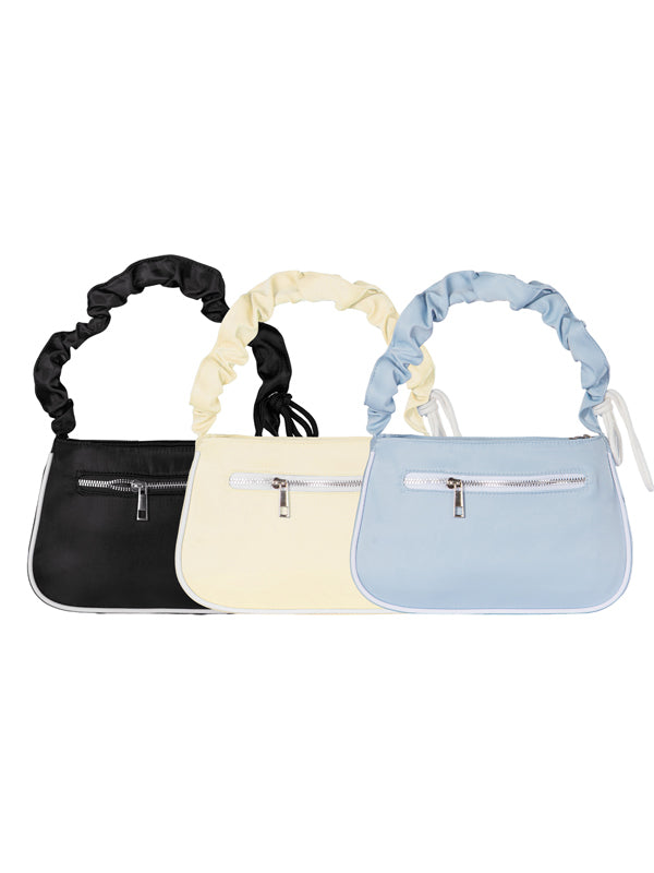 Three small handbags in black, beige, and light blue with scrunchie handles on a white background.