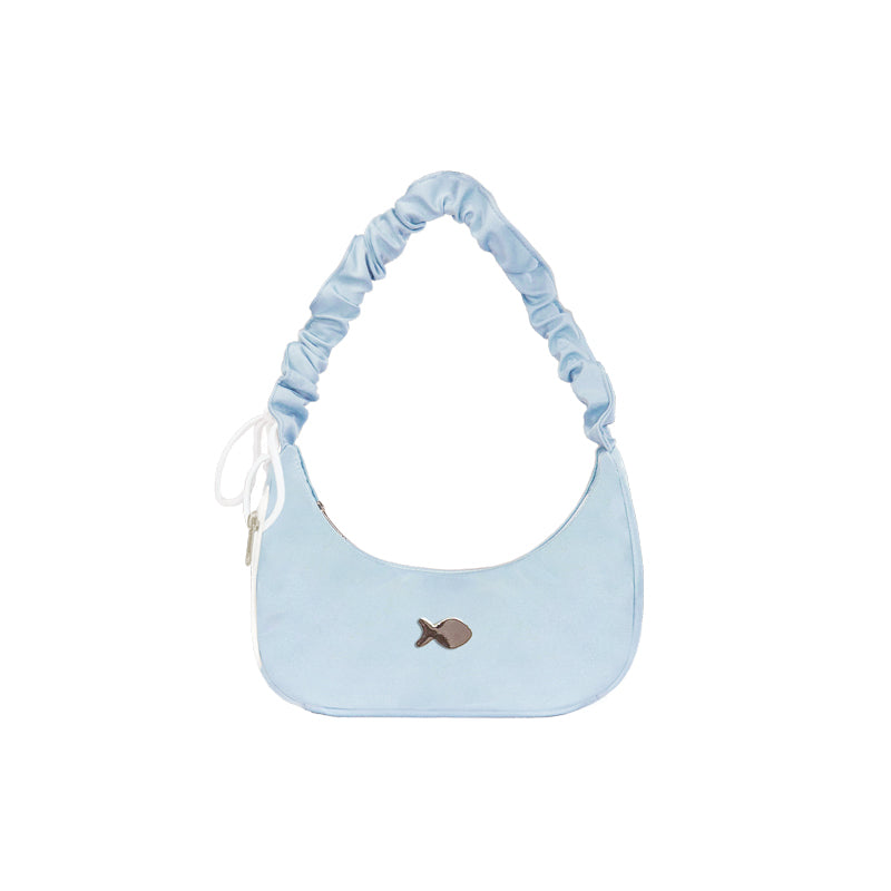 Light blue handbag with a small decorative element on a white background