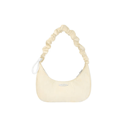 Cream-colored handbag with a ruched handle on a white background