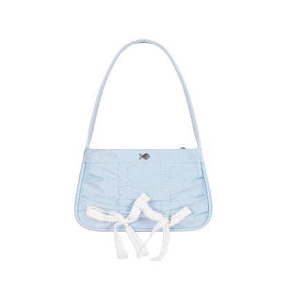 Light blue handbag with white lace details on a white background