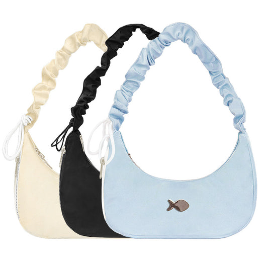 Three handbags in beige, black, and light blue with ruched handles on a white background.