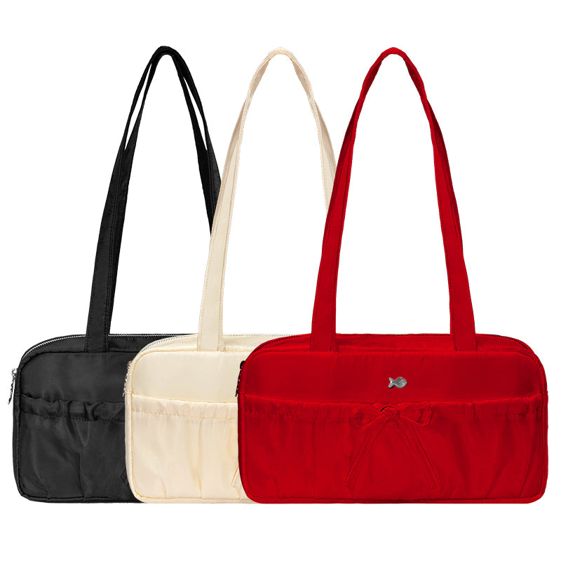 Three handbags in black, beige, and red on a white background