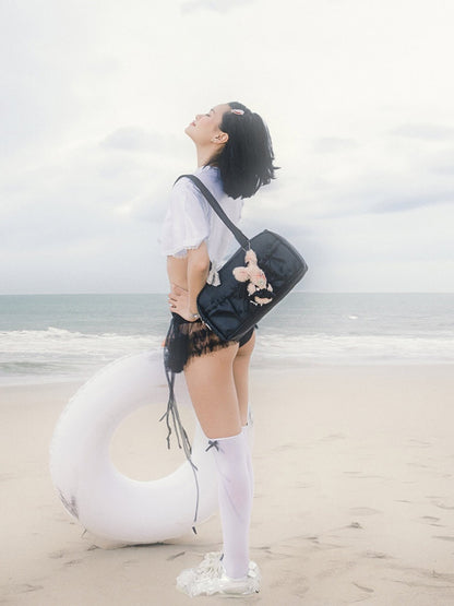 Person standing on a beach with a white inflatable ring and black bag